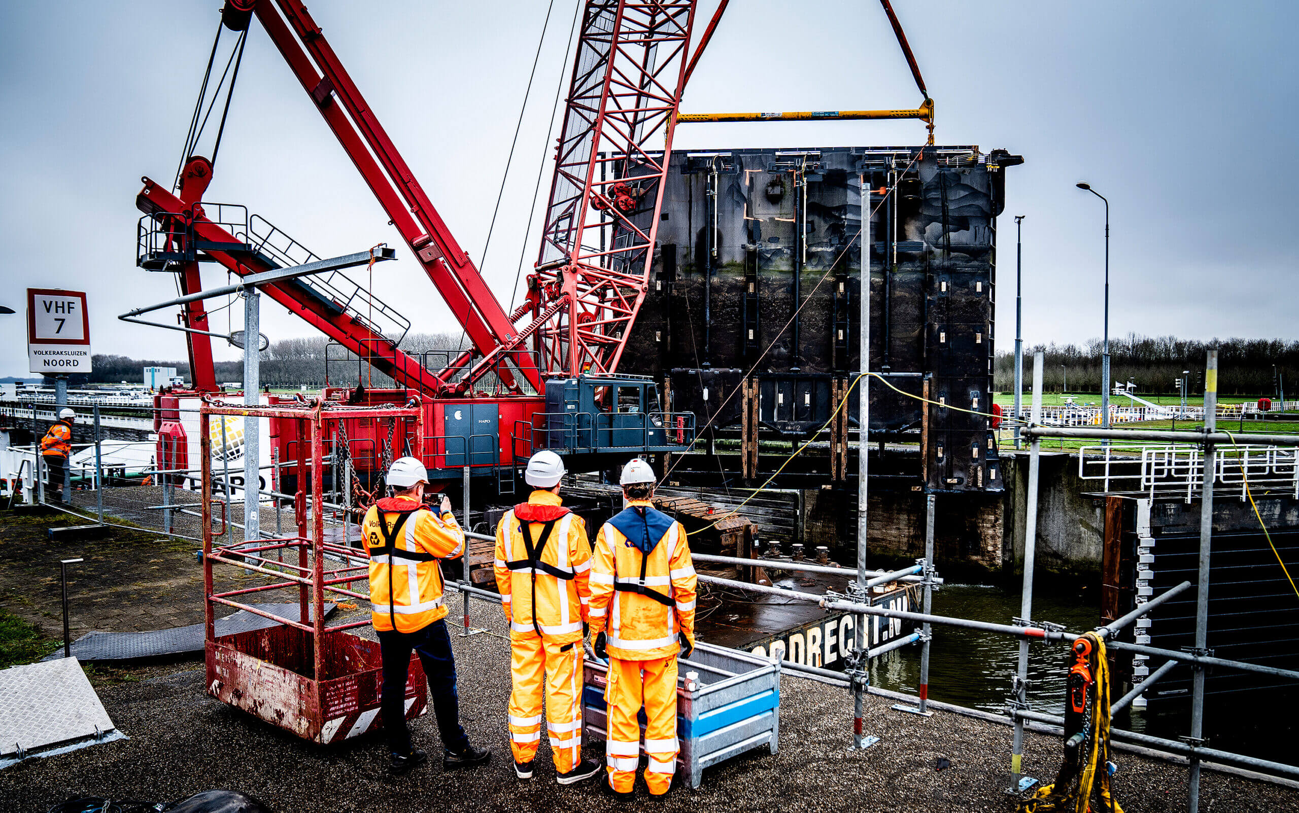 Employees watching the lock system getting lifted